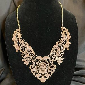 Metal lace bib gold tone necklace with pink overlay